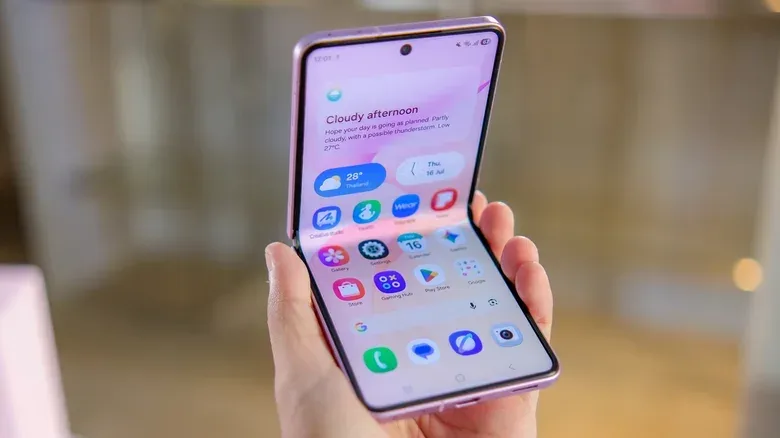 A hand holding up the Samsung Galaxy Z Flip 8 phone.
