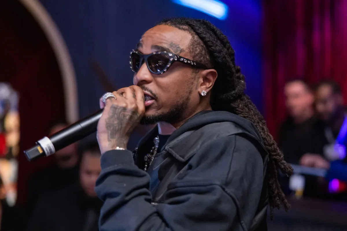 Quavo performing onstage during a live music appearance