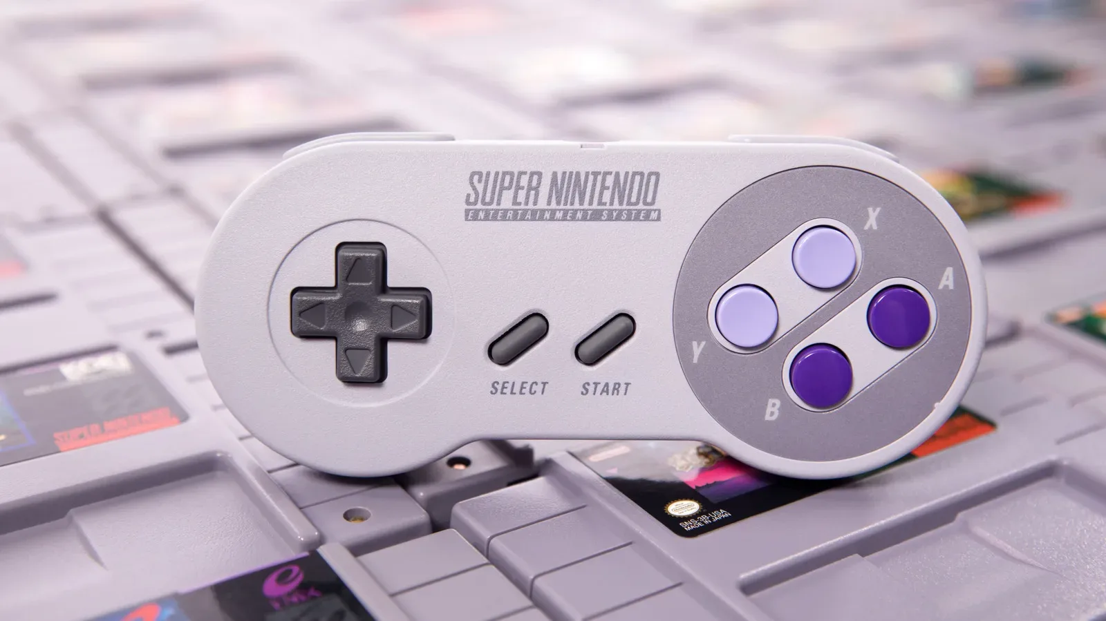 A collection of original SNES game cartridges arranged on a shelf