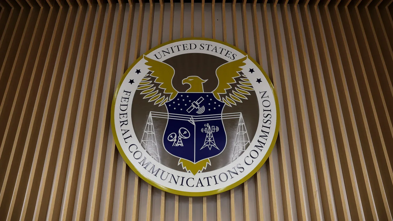 A correctional facility exterior with a cellphone signal graphic illustrating proposed jamming rules