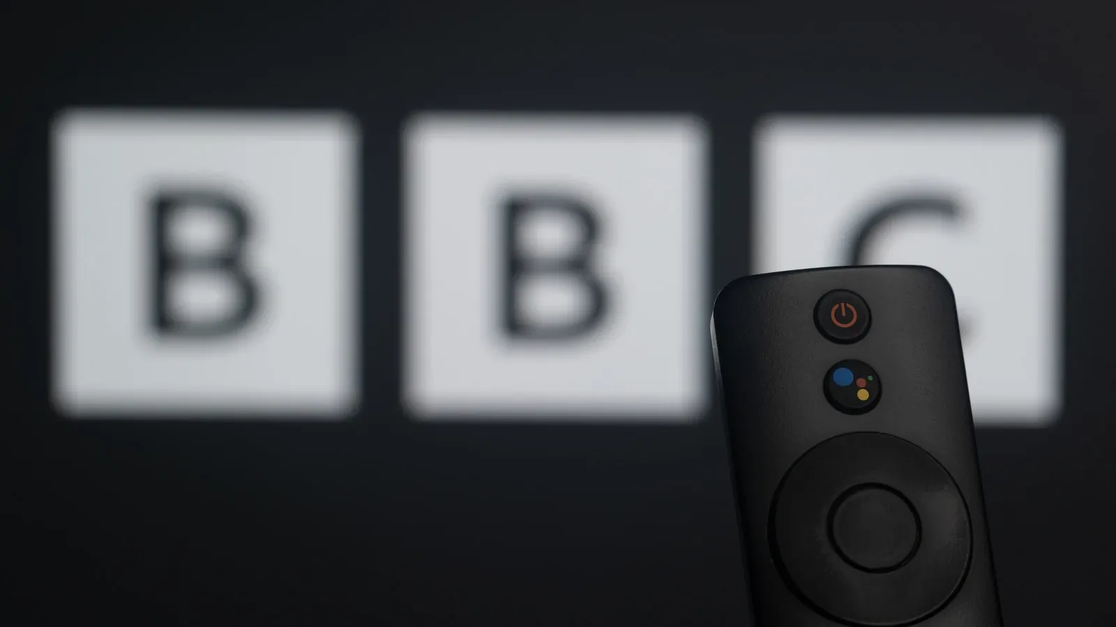 YouTube displayed on a mobile device beside a television remote