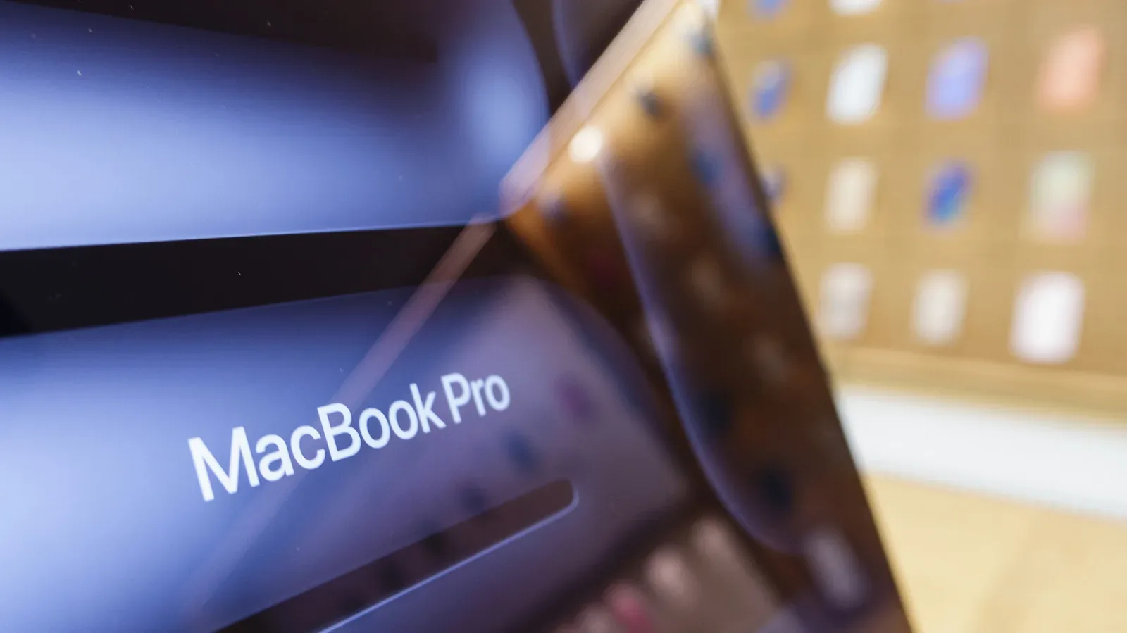 Conceptual Apple MacBook Pro showing an OLED display and touch interaction